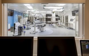 An interior window looking into an operating room